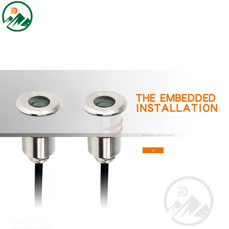 Mini in-ground LED luminaire installed in a garden path with water pooling around it
