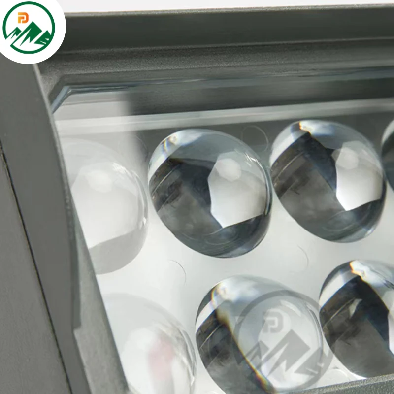 Wall-mounted LED luminaire installed on a building facade at night
