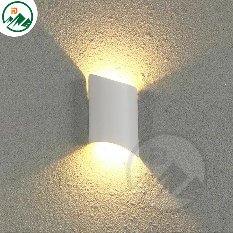 Wall-mounted LED fixture in white finish installed on a modern building facade