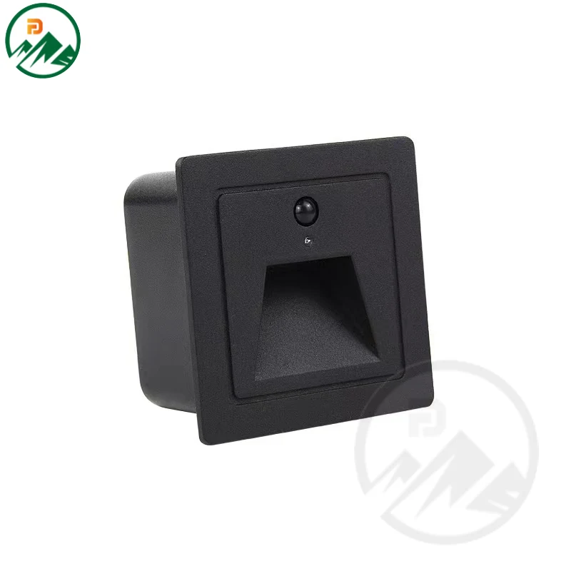 Recessed underground corner light installed in paving with the sensor housing visible