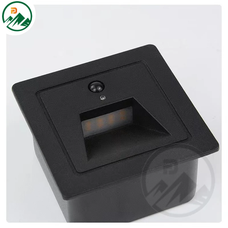 Fixture installed at a building corner with motion-activated lighting at night