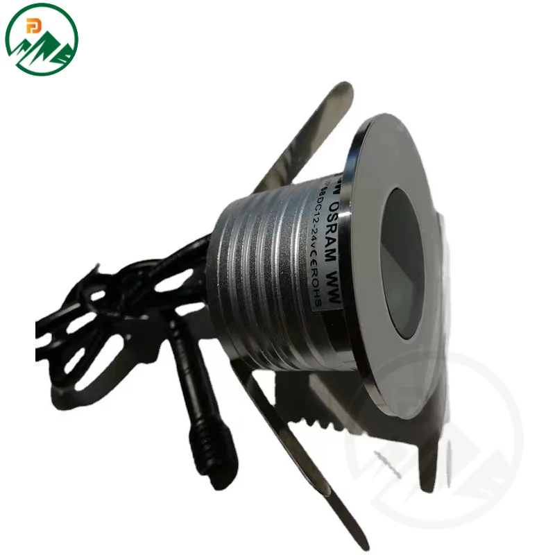 In-ground luminaire installed flush in paving with half-mask cover directing light downward