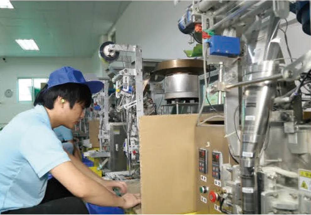 Operator running a packing machine on the FIGHTING production line