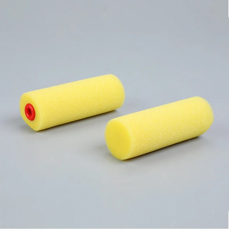 Two 4 inch yellow foam paint roller covers with red inner core on gray background