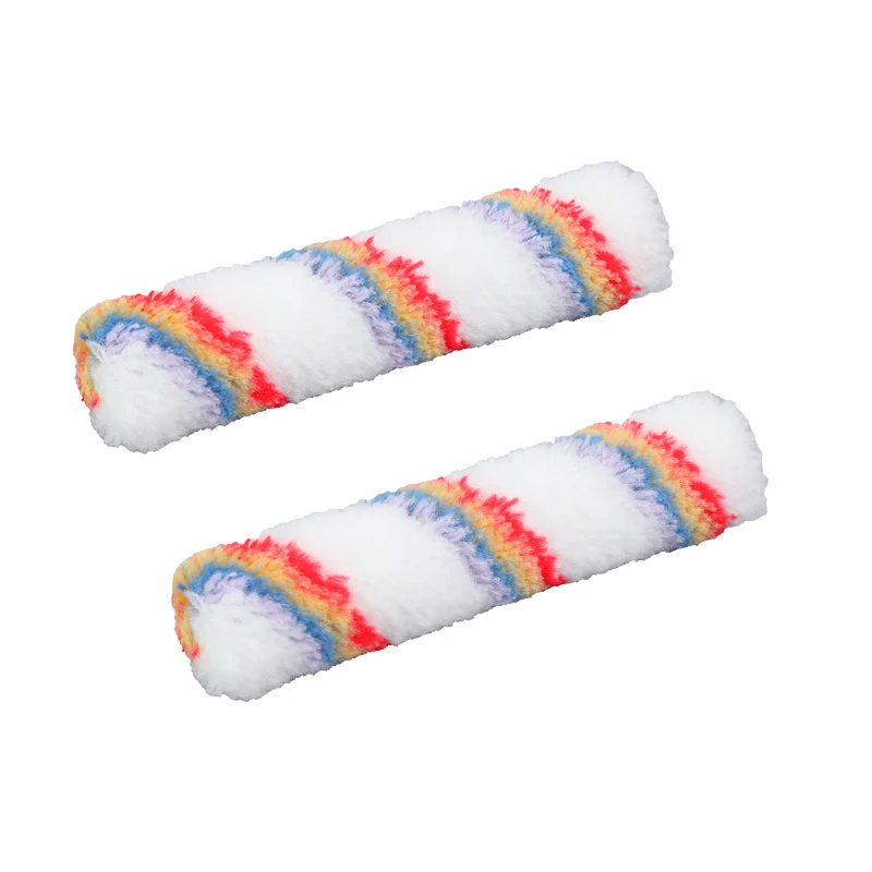 Two white paint roller covers with red, blue, yellow and purple stripes on a plain white background
