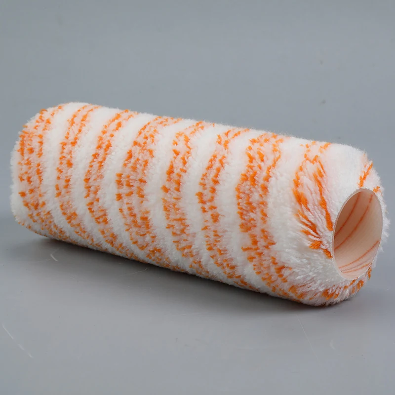 White paint roller cover with orange striped fibrous nap lying on a plain gray background