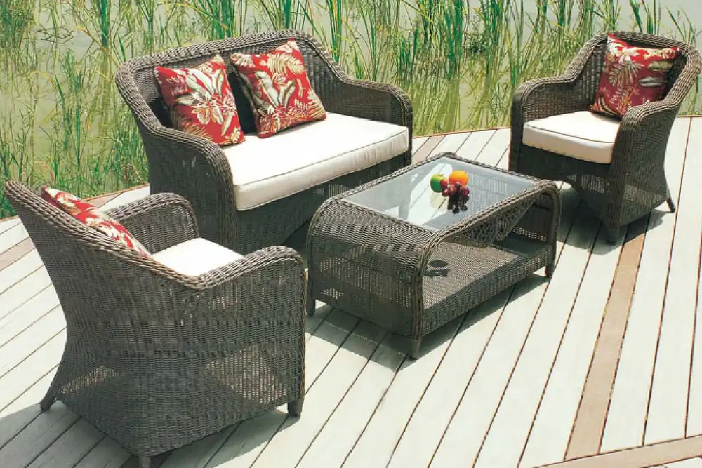 Rattan outdoor armchair set with glass top coffee table and cushions