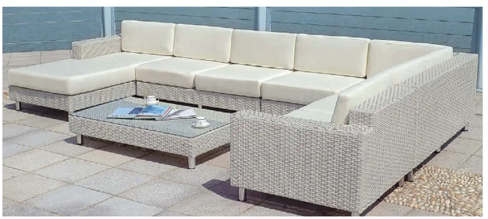 Large beige rattan outdoor sectional sofa with glass top coffee table