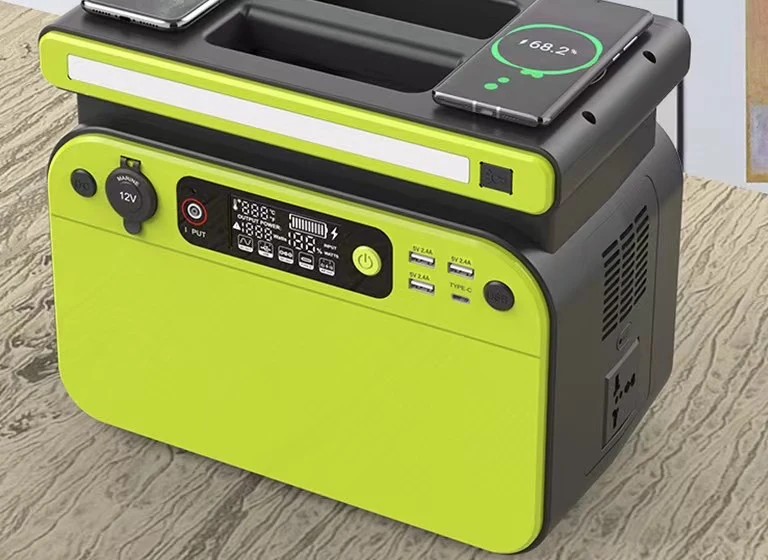 Lime green portable power station with two wireless charging pads holding smartphones, digital display, AC outlets and USB ports