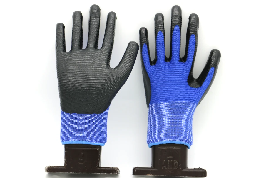 Pair of blue knit work gloves with black coated palms, shown front and back on black display stands against white background