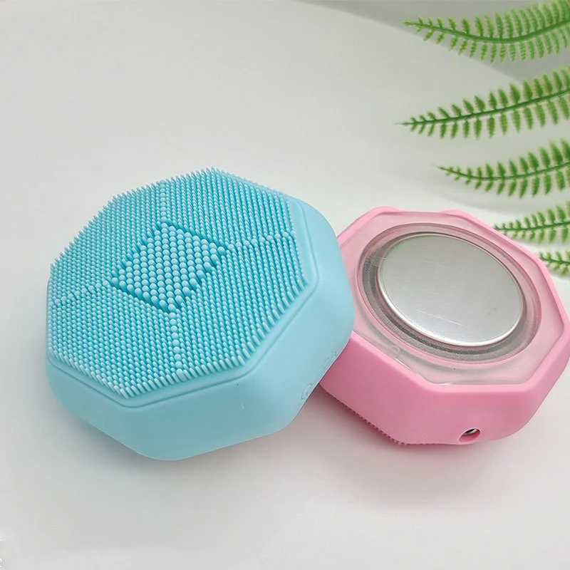 Silicone facial brush with LED therapy and heat function in use on the face