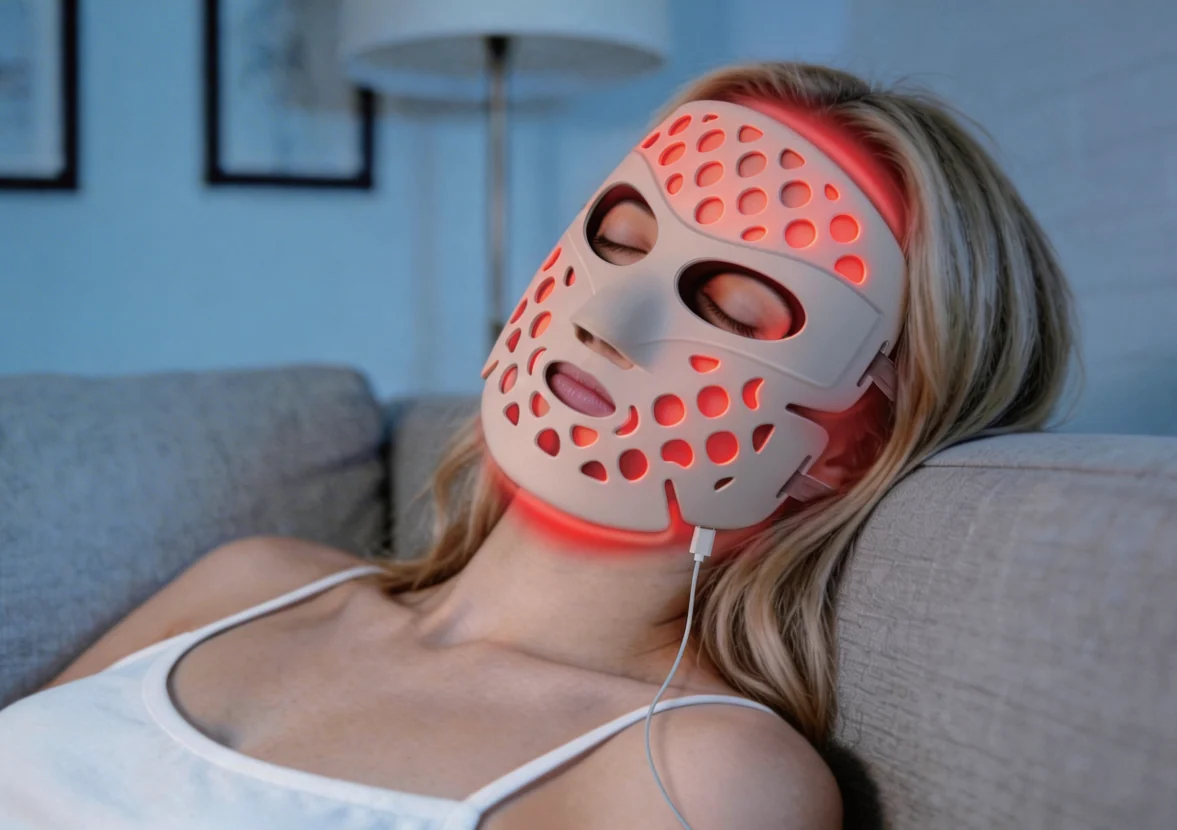 Woman relaxing while wearing an LED light therapy face mask