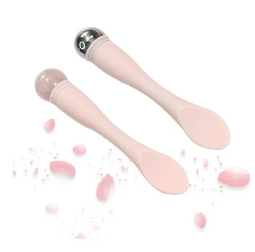 Eye massage stick with silicone spoon and massage stick ends in use on under-eye area