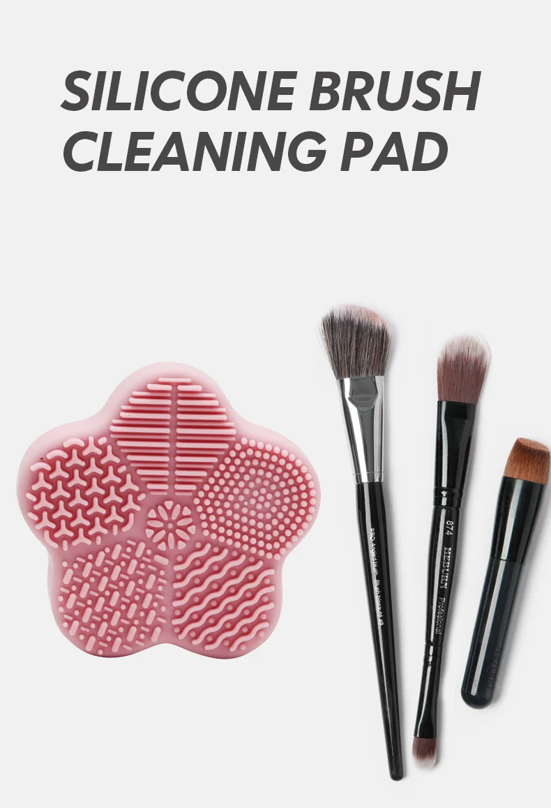 Brush cleaning pad shown with a foundation brush and a powder brush