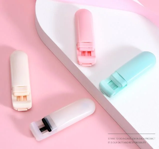 Eyelash curler tool held in hand with a close-up of the silicone tip