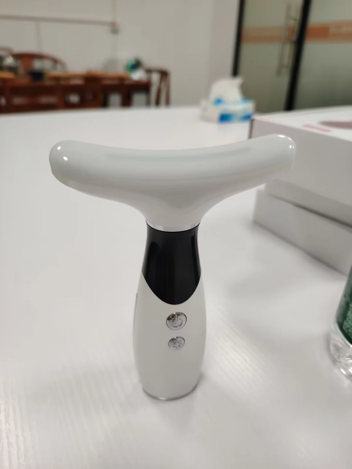 Skin care LED therapy neck massage device in use