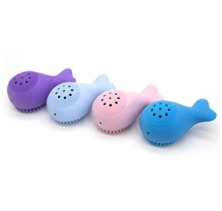 Silicone whale-shaped face wash brush in use on a person's face