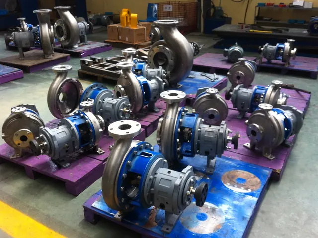 Partly assembled centrifugal pumps lined up on the assembly floor