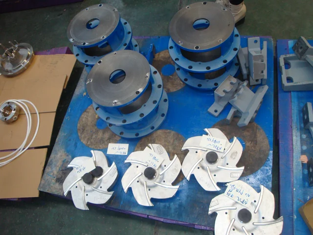 Machined closed impellers and flanged casings laid out for assembly
