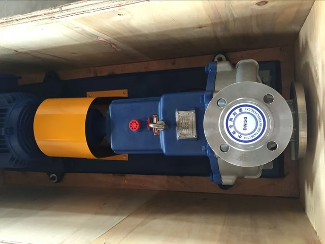Orange centrifugal pump secured inside an open export crate