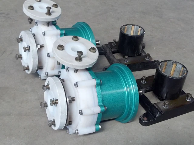 Two polypropylene lined centrifugal pumps with stainless flanges on the assembly floor