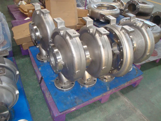 Stainless steel centrifugal pump volute casings staged on a pallet after casting and machining
