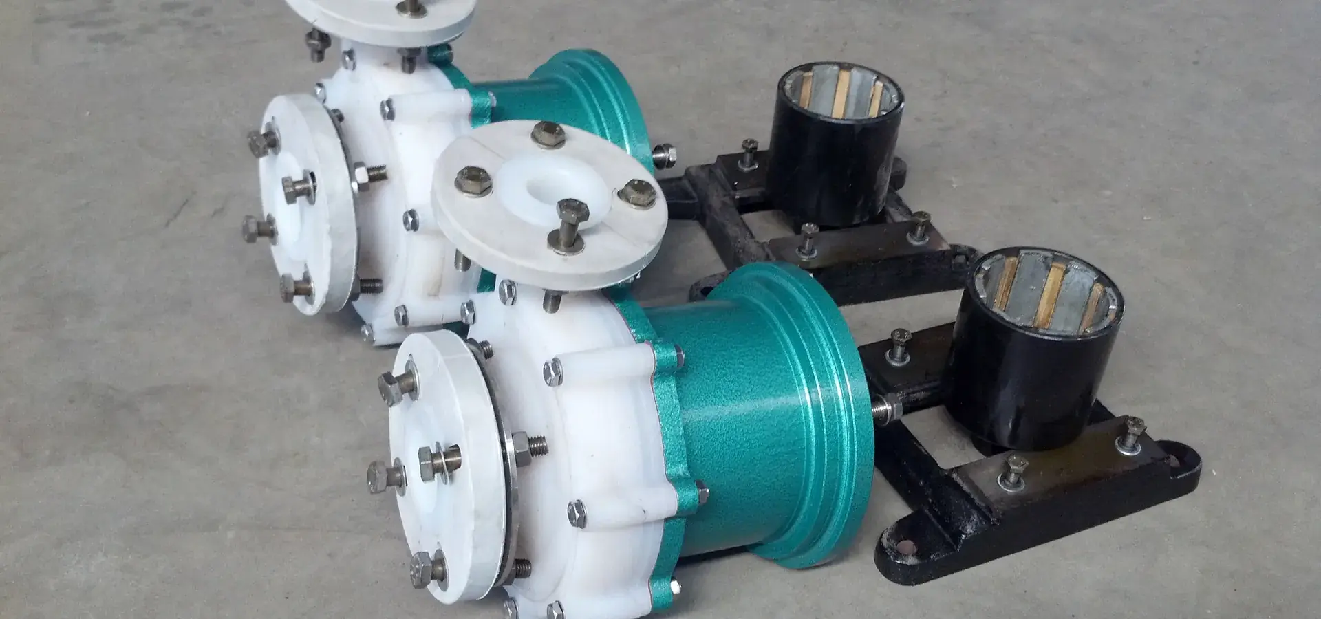 Two polypropylene lined centrifugal pumps with stainless flanges on the assembly floor