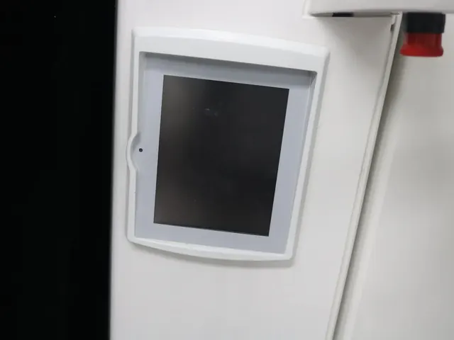 ProOne brand logo etched on the white column of the Planmeca panoramic X-ray machine