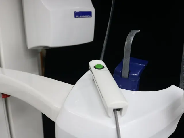 Patient positioning assembly of the Planmeca ProOne — dual metal temple support arms and blue disposable bite block holder