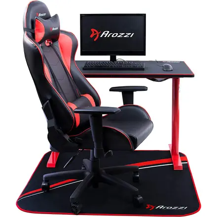 Gaming chair and desk standing on a black and red printed chair mat