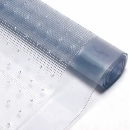 Roll of PVC carpet protector showing the clear ribbed surface