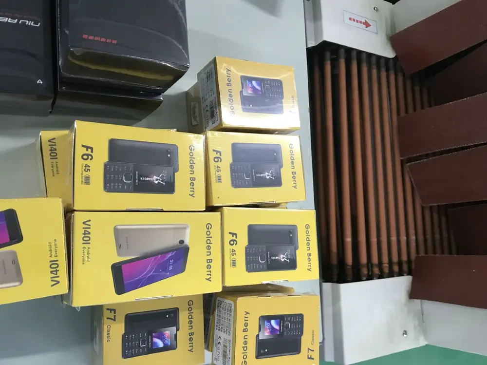 Golden Berry retail cartons staged beside the assembly line at the Shenzhen factory