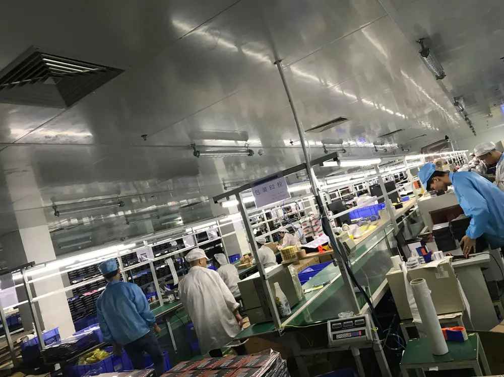 The Golden Berry assembly floor in Shenzhen with operators working along both sides of the production line
