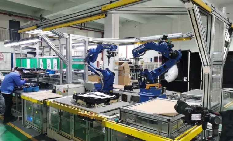 Automated production cell with robotic arms handling parts at a conveyor line