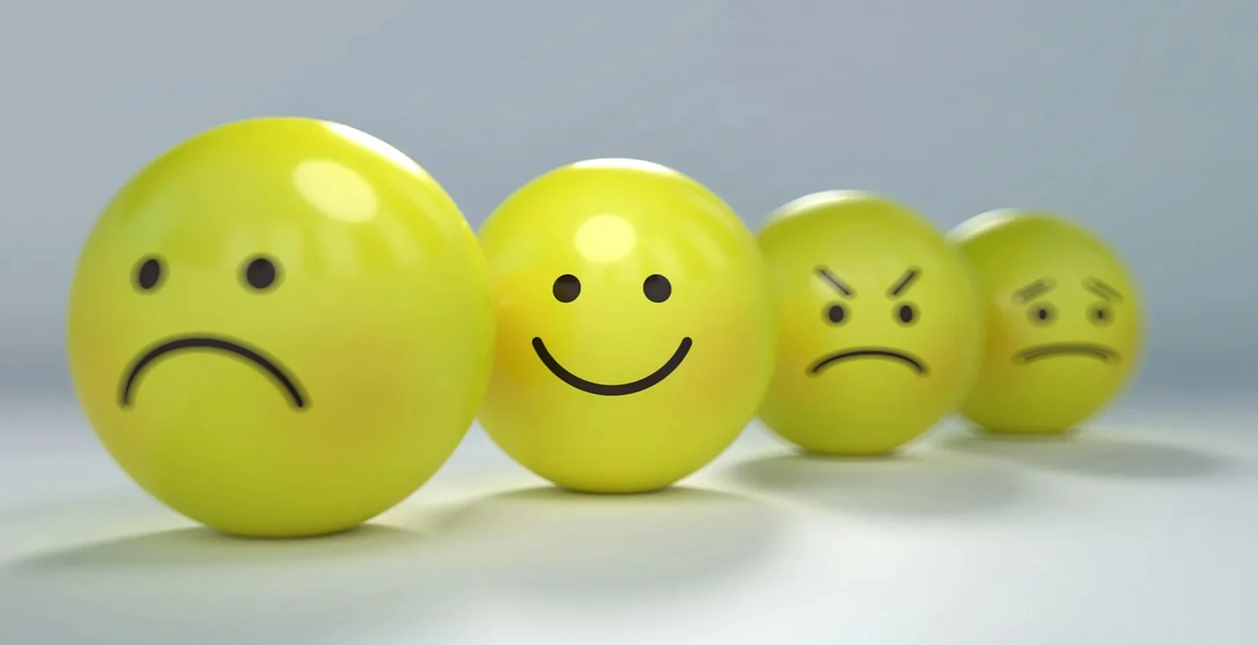 Row of expression spheres representing varying customer satisfaction outcomes