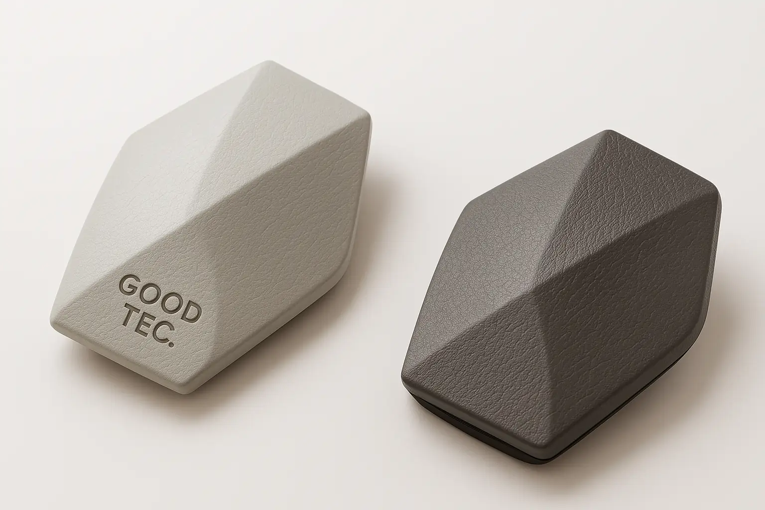 Two faceted car diffuser bodies in stone and grey finishes with GOOD TEC branding