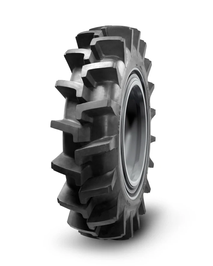 PR-1 bias agricultural tyre for paddy field, showing deep tread pattern and wide section on a tractor wheel