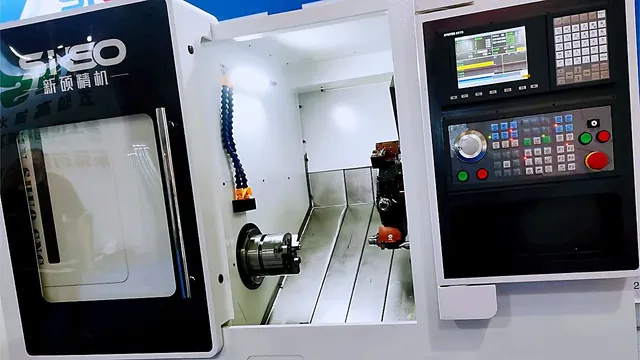 CNC turning centre with the tool and workpiece visible through the guard