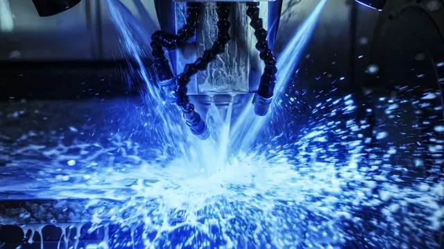 Milling cutter machining a metal part under a spray of blue coolant