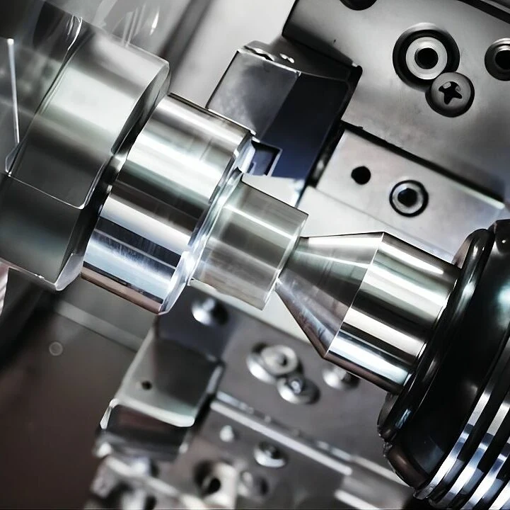 Close view of a lathe machining a stepped metal component