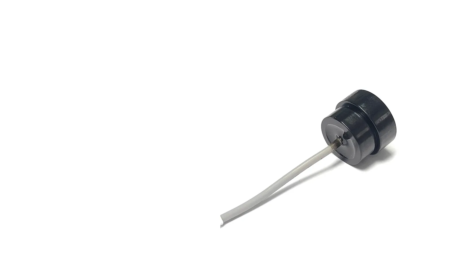 Ultrasonic material recognition transducer with white ceramic emitting face, shown against a white background
