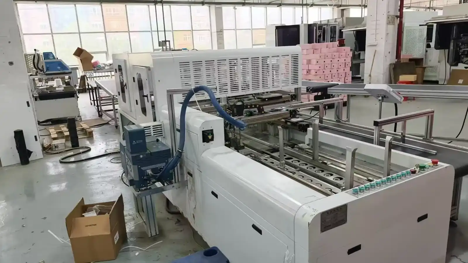 Rigid box assembly machine positioned for commissioning before shipment
