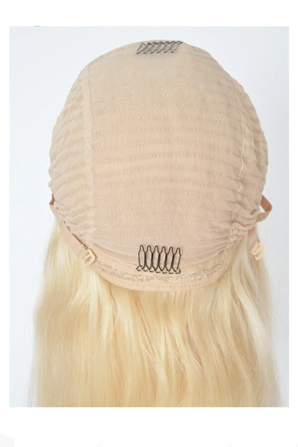 Hair system styled on a mannequin head showing the front parting and natural hairline