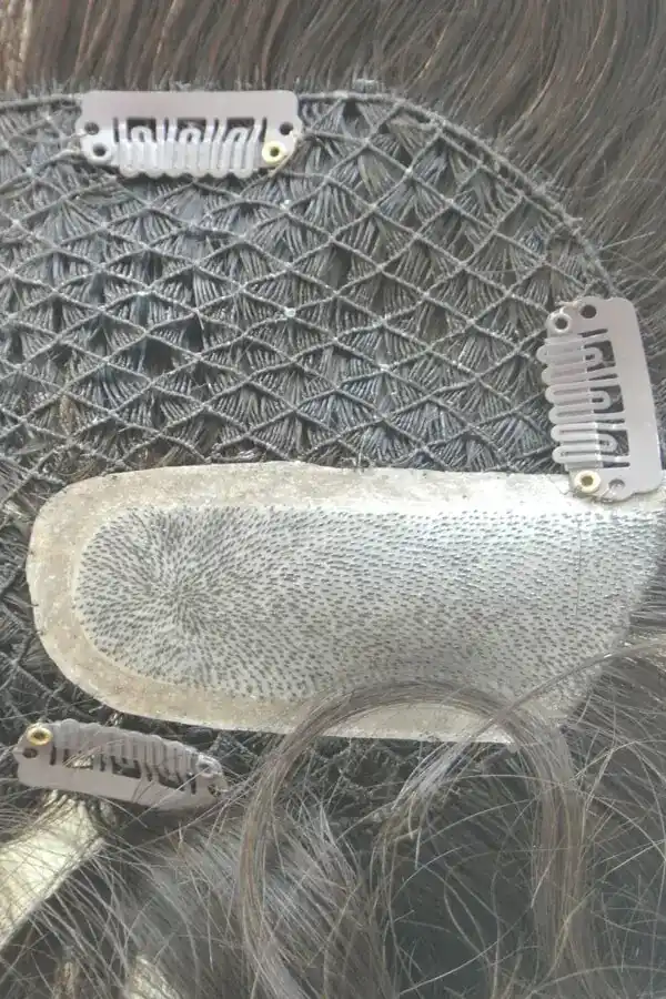 Fish net hair system with injected skin top worn on a mannequin head, showing natural scalp appearance