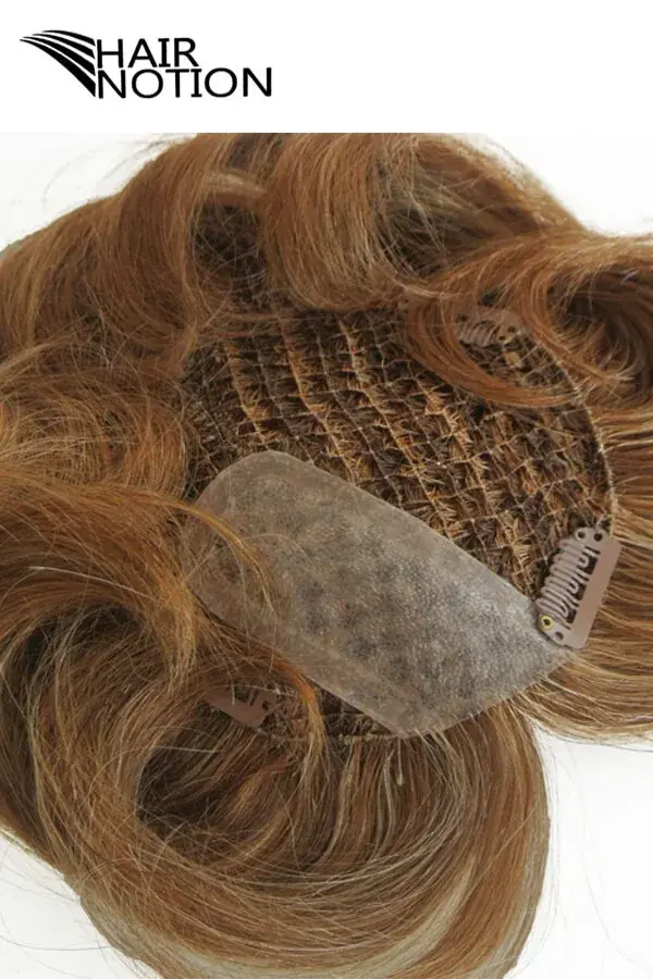 Custom men's hair system with fish net base and injected skin top shown from above, highlighting the natural hairline