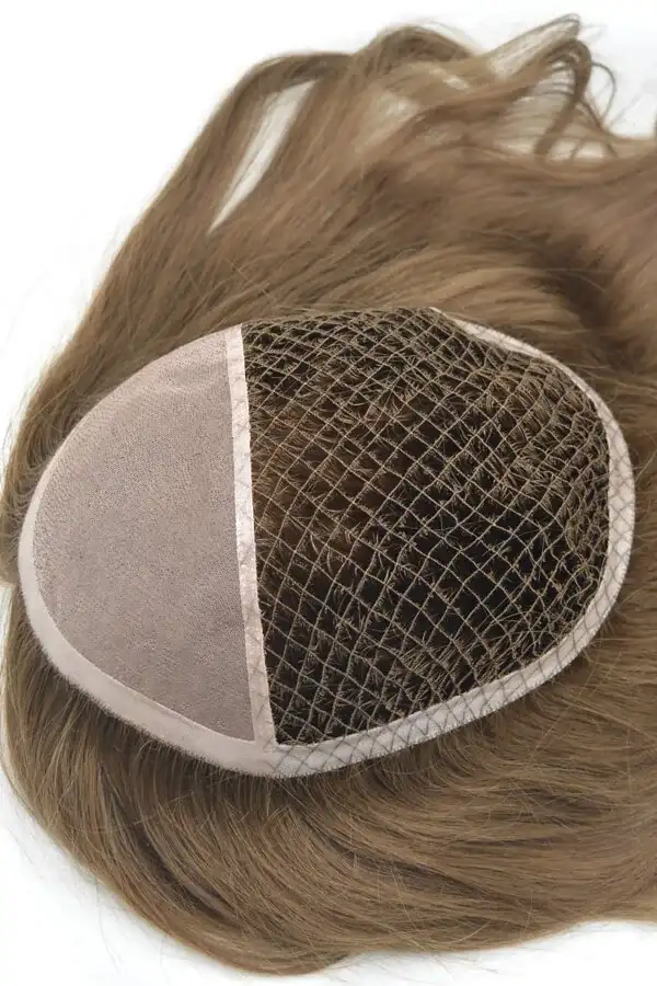 Men's hairpiece styled on a mannequin head, showing the front parting and natural hairline