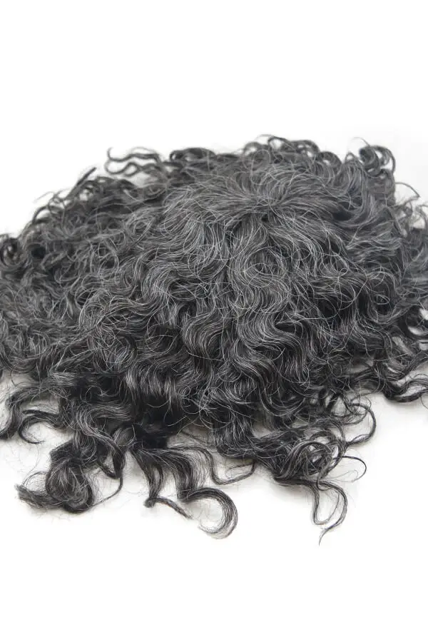 Side view of a wave-style human hair toupee for men, highlighting the folded net and durable base