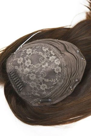 SAURA topper styled on a woman's head with the hair parted naturally
