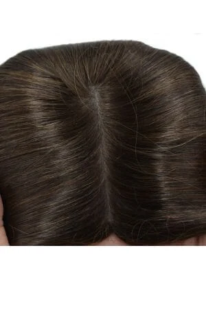Close-up of the SAURA silk top base showing the smooth, natural-looking scalp appearance
