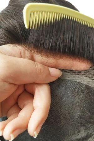 Toupee worn on a mannequin head showing the front parting and natural hairline